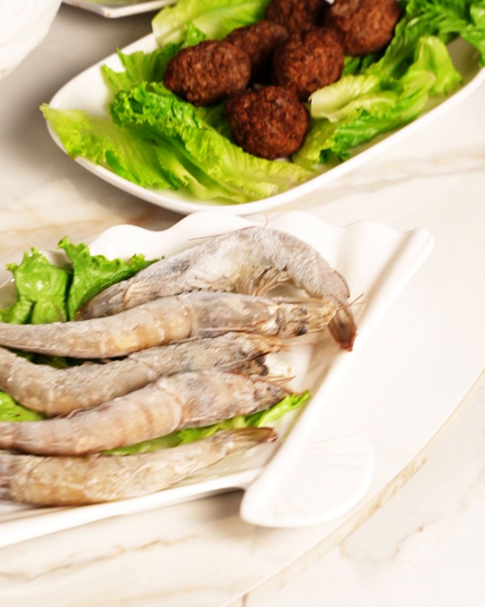 White shrimp and handmade balls plated on lettuce